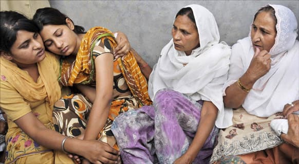 Wife Sukhpreet Kaur, sister Dalbir Kaur and Poonam and Swapandeep, daughters of Sarabjit Singh, mourn during his funeral at Bhikhiwind.