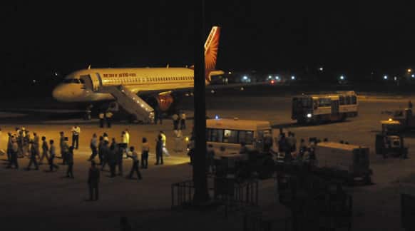 Officials wait as an Air India aircraft carrying the body of Sarabjit Singh arrives at the airport in Amritsar.