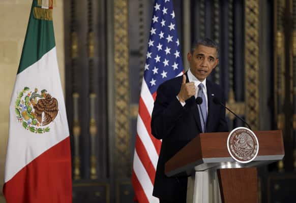 President Barack Obama answers questions during his news conference with Mexico’s President Enrique Pena Nieto, at the Palacio Nacional in Mexico City.