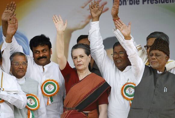 Sonia Gandhi and other senior party leaders wave to their supporters during a campaign rally in Bangalore.