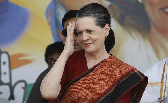 Sonia Gandhi gestures to supporters during a campaign rally for the upcoming Karnataka state election in Bangalore.