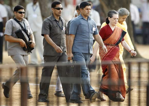 Sonia Gandhi followed by armed security personnel arrives for a campaign rally for the upcoming Karnataka state election in Bangalore.