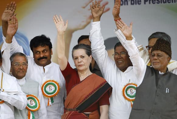 Congress party president Sonia Gandhi and other senior party leaders wave to their supporters during a campaign rally for the upcoming Karnataka state election in Bangalore.