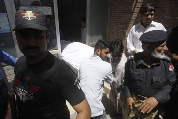 Pakistani hospital staff transfer the body of jailed Sarabjit Singh after an autopsy at a local hospital in Lahore, Pakistan.