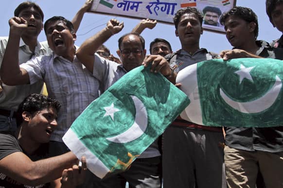 People shout slogans and burn a flag of Pakistan after Sarabjit Singh, a convicted Indian who was on Pakistan`s death row, died from a head injury after two inmates attacked him with a brick in a Lahore jail, in Ahmadabad.