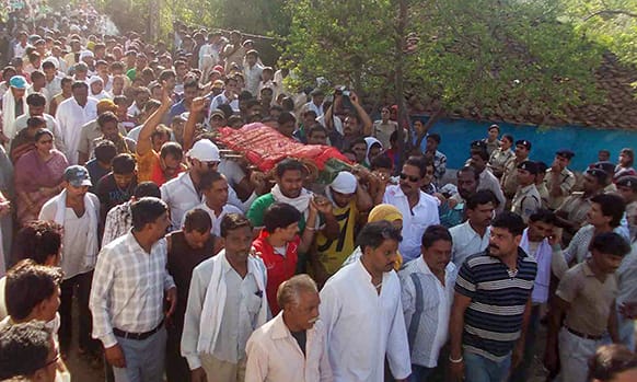 Indians carry the body of a 5-year-old girl who died at a hospital where she was being treated for injuries after being raped, in Ghansor, Seoni district of Madhya Pradesh state, India.