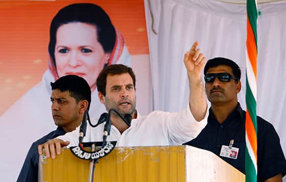 Congress party leader Rahul Gandhi, center, flanked by security personnel speaks during a campaign rally for the upcoming state elections in Tumkur, 70 Kilometers (43 miles) northwest of Bangalore.