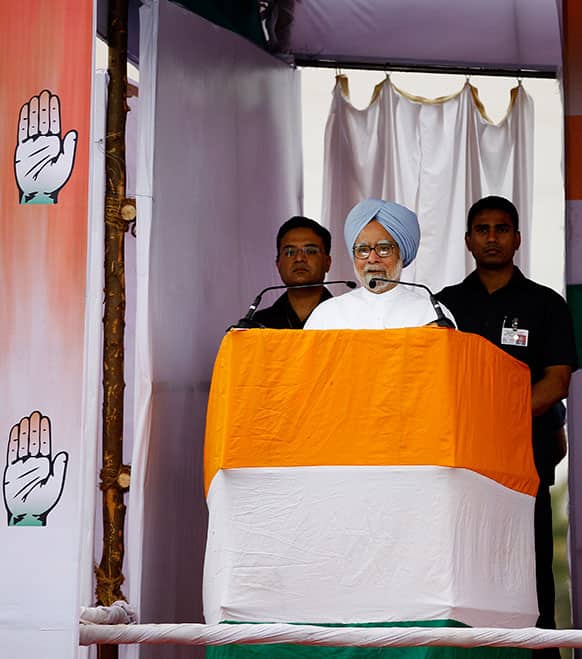 Prime Minister Manmohan Singh flanked by security personnel speaks at a campaign rally for the upcoming Karnataka state election on the outskirts of Bangalore.
