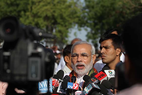 Gujarat state chief minister Narendra Modi, center, speaks to the media on Gujarat Foundation Day in Ahmadabad.