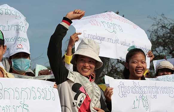 Cambodian garment factory workers smile during a rally to mark the May Day in Phnom Penh, Cambodia.