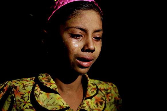 A Muslim girl weeps as she flees her village, in Okkan, Yangon, Myanmar. Buddhist mobs hurling bricks overran a pair of mosques and set hundreds of homes ablaze in central Myanmar injuring at least 10 people in the latest anti-Muslim violence to shake the Southeast Asian nation.
