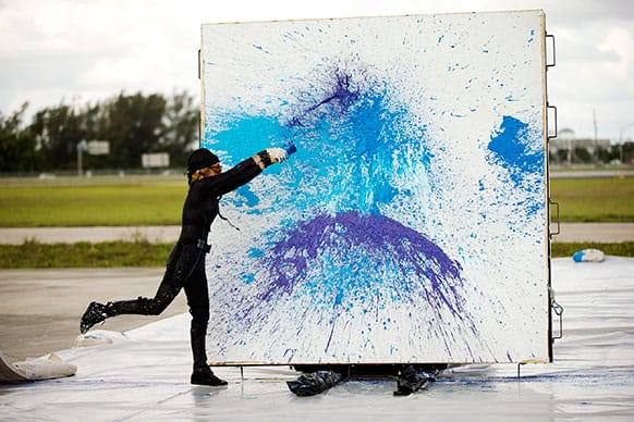 Princess Tarinan von Anhalt works on one of her paintings on the West Palm Beach, Fla. airport tarmac.