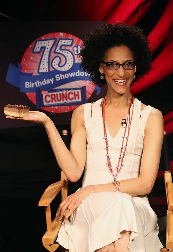 Carla Hall holds the winning treat, baked by Sweet Mandy B`s, at the Nestle Crunch 75th Birthday Showdown in Los Angeles.
