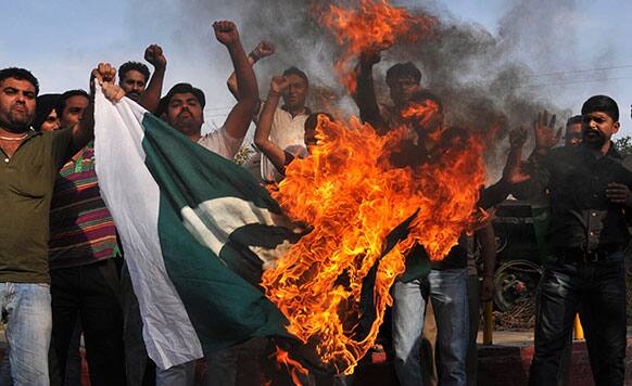 Indian youths protest against the attack on Indian prisoner Sarabjit Singh at a jail in Lahore burn a Pakistani flag and shout slogans in Amritsar.
