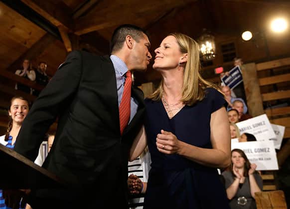 Republican candidate for the US Senate Gabriel Gomez, left, kisses his wife, Sarah, as he takes to the stage before addressing an audience with a victory speech at a watch party, in Cohasset, Mass.