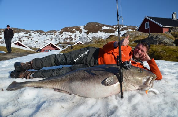 German angler Michael Eisele poses with the 47 kg cod fish measuring 160 cm that he caught in the Breivikfjord near Hammerfest, northern Norway.