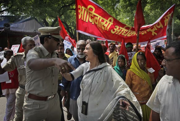 Communist Party of India leader Brinda Karat argues with a police officer as she with other tribals participate in a march to highlight tribal people`s rights to land, forest and water surrounding their settlements, in New Delhi.