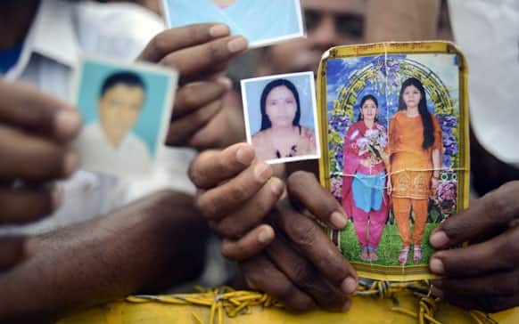 Family members hold portraits of their missing friends and family, in Savar, near Dhaka, Bangladesh.