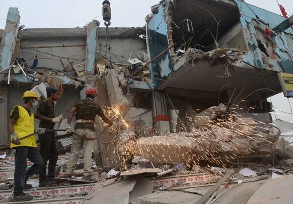 Workers toil in the collapsed garment factory building on Monday 29 April, 2013 in Savar, near Dhaka, Bangladesh.