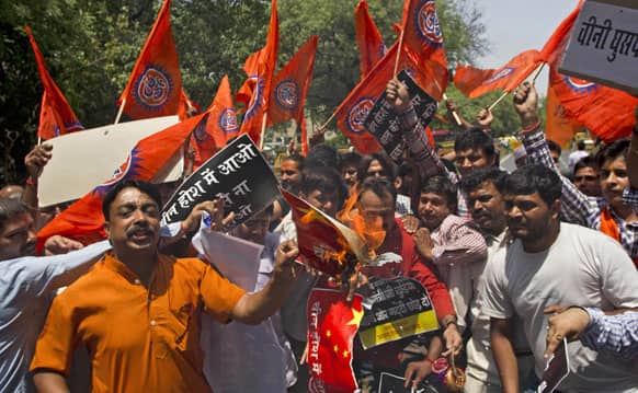 Bharatiya Janata Party youth wing activists burn a Chinese flag during a protest against the alleged incursion by Chinese troops into Indian territory in New Delhi.