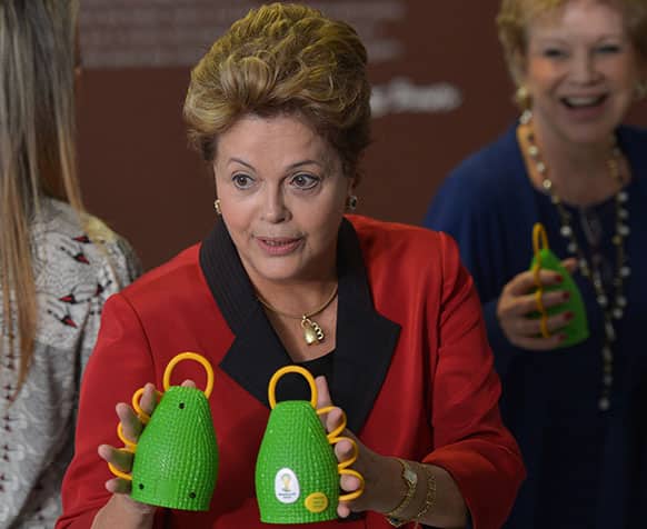 Brazil`s President Dilma Rousseff holds caxirolas during their official presentation at the Planalto Palace, in Brasilia, Brazil.