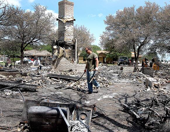 Brian Kaska walks through the remains of his home in one of the most devastated the areas of West, Texas.