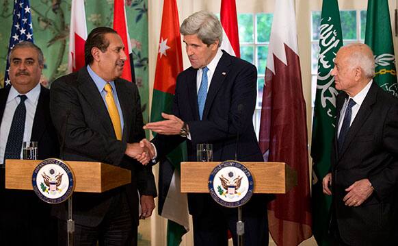 Secretary of State John Kerry, second from right, shakes hands with the Qatar`s Prime Minister and Foreign Minister Hamad bin Jassim bin Jabr Al-Thani, second from left, who is leading the Arab League, following their meeting at Blair House in Washington.