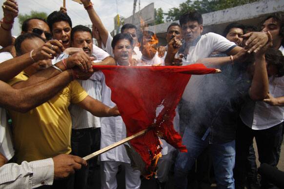 Bharatiya Janata Party youth wing activists burn a homemade Chinese flag during a protest against the alleged incursion by Chinese troops into Indian territory, in Jammu.