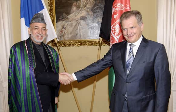Finnish President Sauli Niinisto, right, and Afghan President Hamid Karzai shake hands in Helsinki, Finland.