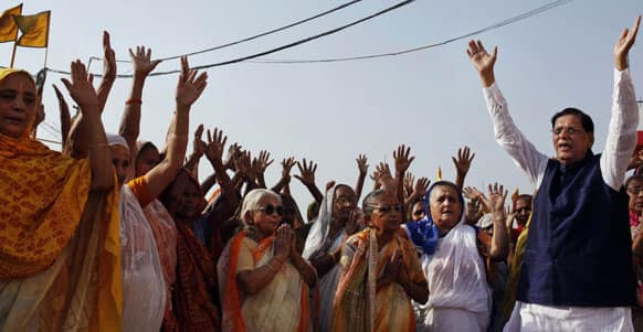 Social reformer and chairperson of non-governmental organization (NGO) Sulabh International Bindeshwar Pathak, performs morning prayers with elderly widows on the banks of the holy River Ganges in Varanasi.