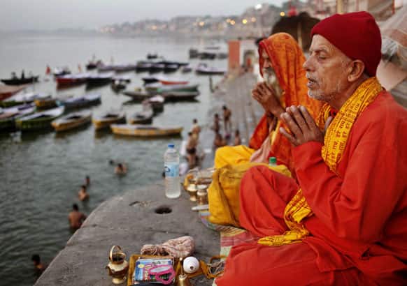 Hindu devotees offer prayers in the morning on the banks of the holy River Ganges in Varanasi.