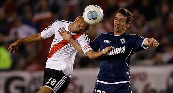 River Plate`s Cristian Ledesma, left, fights for the ball with Quilmes` Fernando Elizari during an Argentina`s league soccer match in Buenos Aires, Argentina.