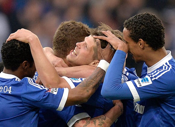 Schalke`s Klaas-Jan Huntelaar of the Netherlands is celebrated by his team after scoring his third goal during the German first division Bundesliga soccer match between FC Schalke 04 and Hamburg SV in Gelsenkirchen, Germany.