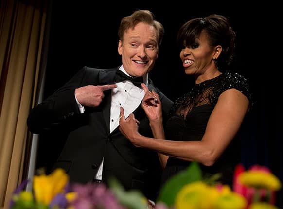 First lady Michelle Obama and late-night television host and comedian Conan O`Brien gesture to his tie at the White House Correspondents` Association Dinner at the Washington Hilton Hotel, in Washington.