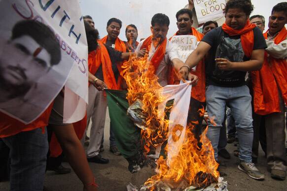Activists of right-winged Rashtrawadi Shiv Sena shout slogans against the Pakistan government and burn their national flag during a protest against an attack on Sarabjit Singh in a Lahore prison, in Jammu.