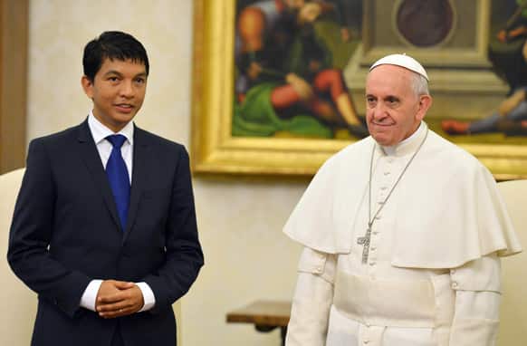 Pope Francis poses for the media with Madagascar President Andry Nirina Rajoelina on the occasion of their private audience at the Vatican.