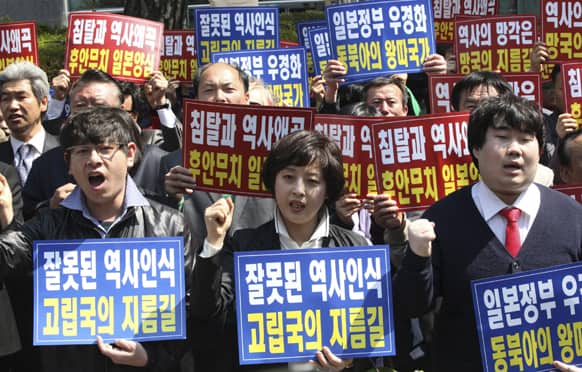 Members of the Korea Freedom Federation shout slogans during a rally to protest Japanese lawmakers`s visit to Yasukuni Shrine in Tokyo, in front of the Japanese embassy in Seoul, South Korea.