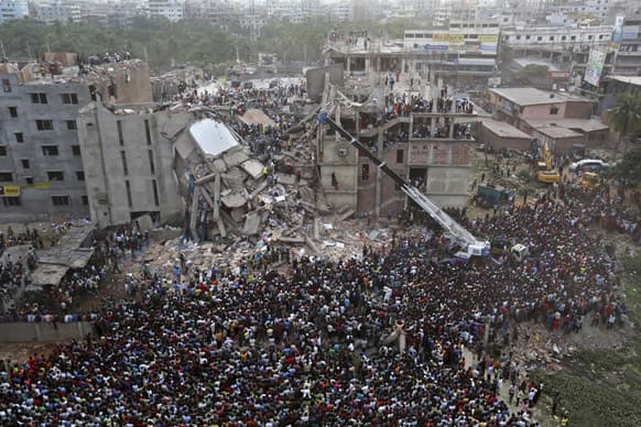 Bangladeshis watch the rescue operations at the site of a building that collapsed Wednesday in Savar, near Dhaka, Bangladesh.