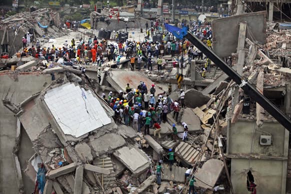 Bangladeshi rescuers work at the site of a building that collapsed Wednesday in Savar, near Dhaka, Bangladesh.