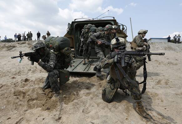 US and South Korean Marines run out from the South Korean LVT-7 as they pose for photographers during the US-South Korea joint military exercises called Ssangyong 2013 as part of their two-month-long Foal Eagle military exercises in Pohang, south of Seoul.
