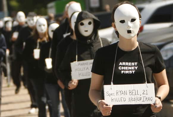 Protesters walk with masks on in Dallas near the dedication of the opening of the George W. Bush Presidential Center in Dallas.
