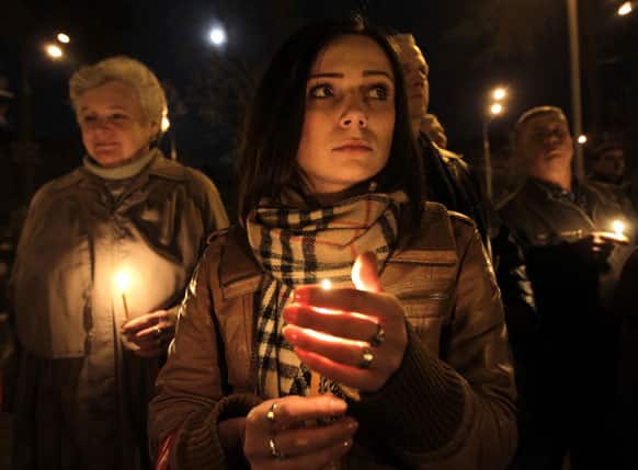 Ukrainians hold candles commemorating the anniversary of the Chernobyl nuclear disaster in the capital city of Kiev, Ukraine.
