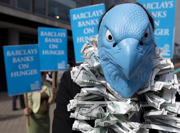 A protester, dressed to look like the Barclays Bank logo, demonstrates outside the Barclays Bank annual general meeting for shareholders, in central London.