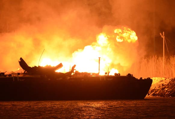 A massive explosion at 3a.m. EDT on one of the two barges still ablaze in the Mobile River in Mobile, Ala. Three people were injured in the blast.