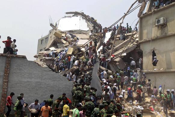 Rescue workers and people look for survivors after an eight-story building housing several garment factories collapsed in Savar, near Dhaka, Bangladesh. Dozens were killed and many more are feared trapped in the rubble.