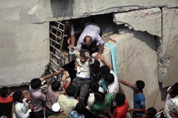 A man who was trapped in an collapsed eight-story building housing several garment factories is reccued in Savar, near Dhaka, Bangladesh.