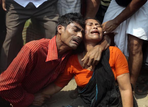 Relatives mourn a victim at the site after an eight-story building housing several garment factories collapsed in Savar, near Dhaka, Bangladesh.