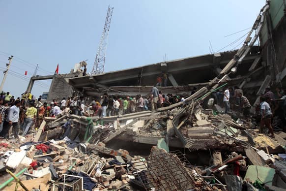 Rescue workers look for survivors after an eight-story building housing several garment factories collapsed in Savar, near Dhaka, Bangladesh.