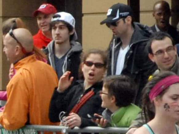 This Monday, April 15, 2013 photo provided by Bob Leonard shows bombing suspects Tamerlan Tsarnaev, 26, center right in black hat, and his brother, Dzhokhar A. Tsarnaev, 19, center left in white hat, approximately 10-20 minutes before the blasts that struck the Boston Marathon.
