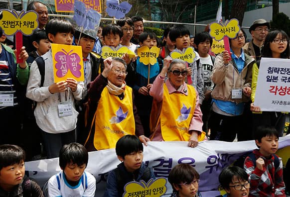 South Koreans, Kim Bok-dong, 87, and Gil Wen-oak, 84, who were forced to serve for the Japanese Army as sexual slaves during World War II, shout slogan in an anti-Japan protest against the Japanese lawmakers` visit to the Yasukuni Shrine, in front of the Japanese Embassy in Seoul.